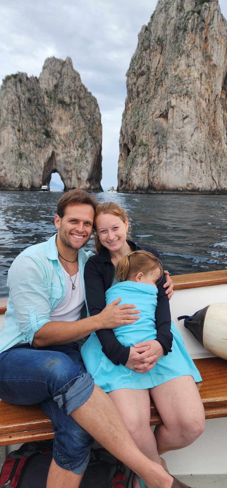 My husband, toddler, and I on a boat in front of Lover's Rock on the isle of Capri, Italy