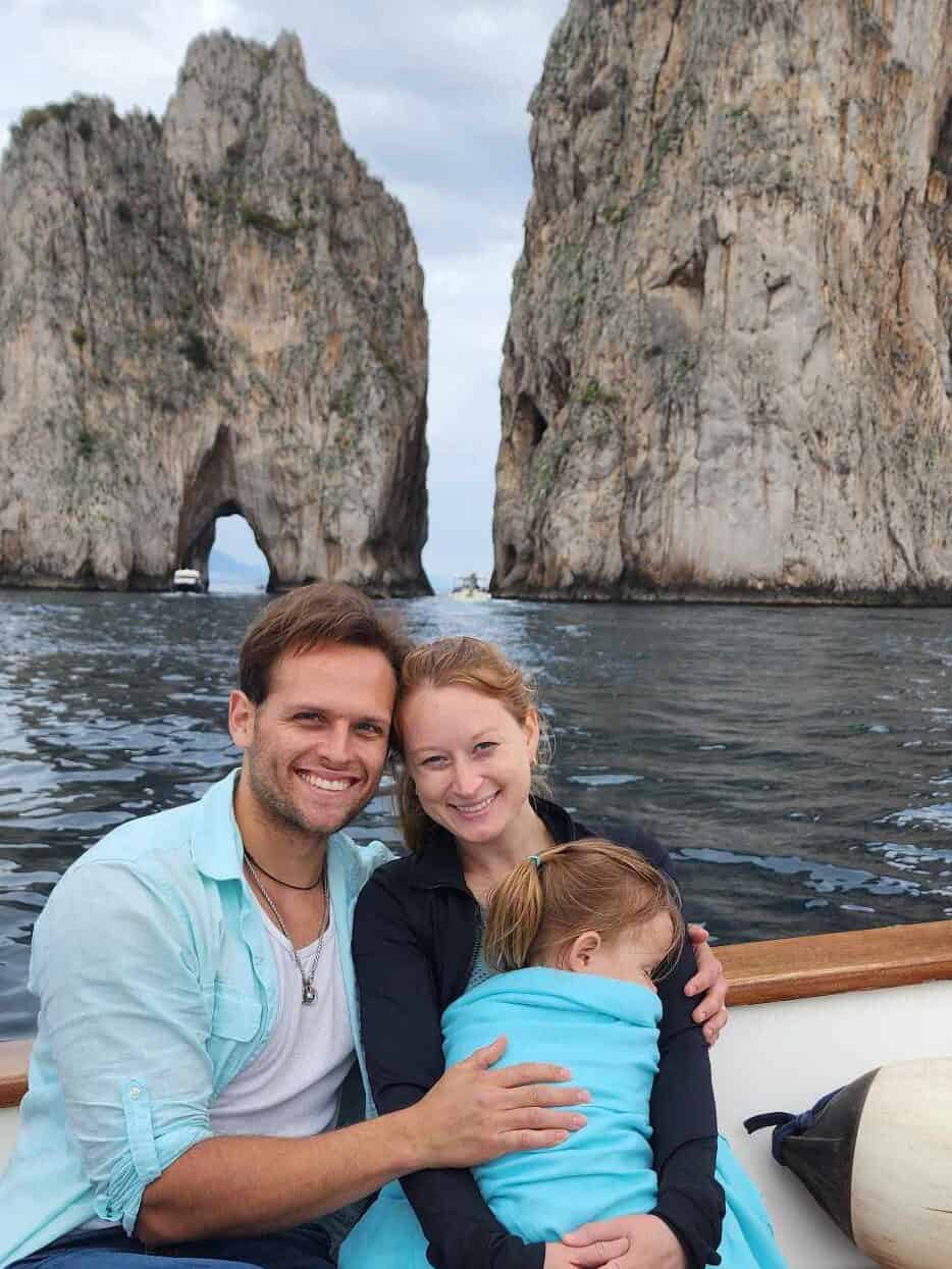 My husband, toddler, and I on a boat in front of Lover's Rock on the isle of Capri, Italy