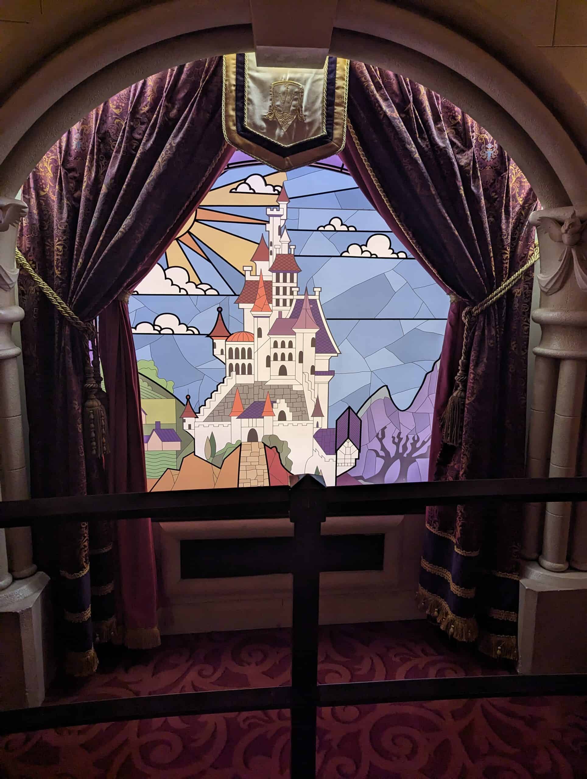 The stained glass window of Belle's Castle featured in the line inside of the Princess Pavilion