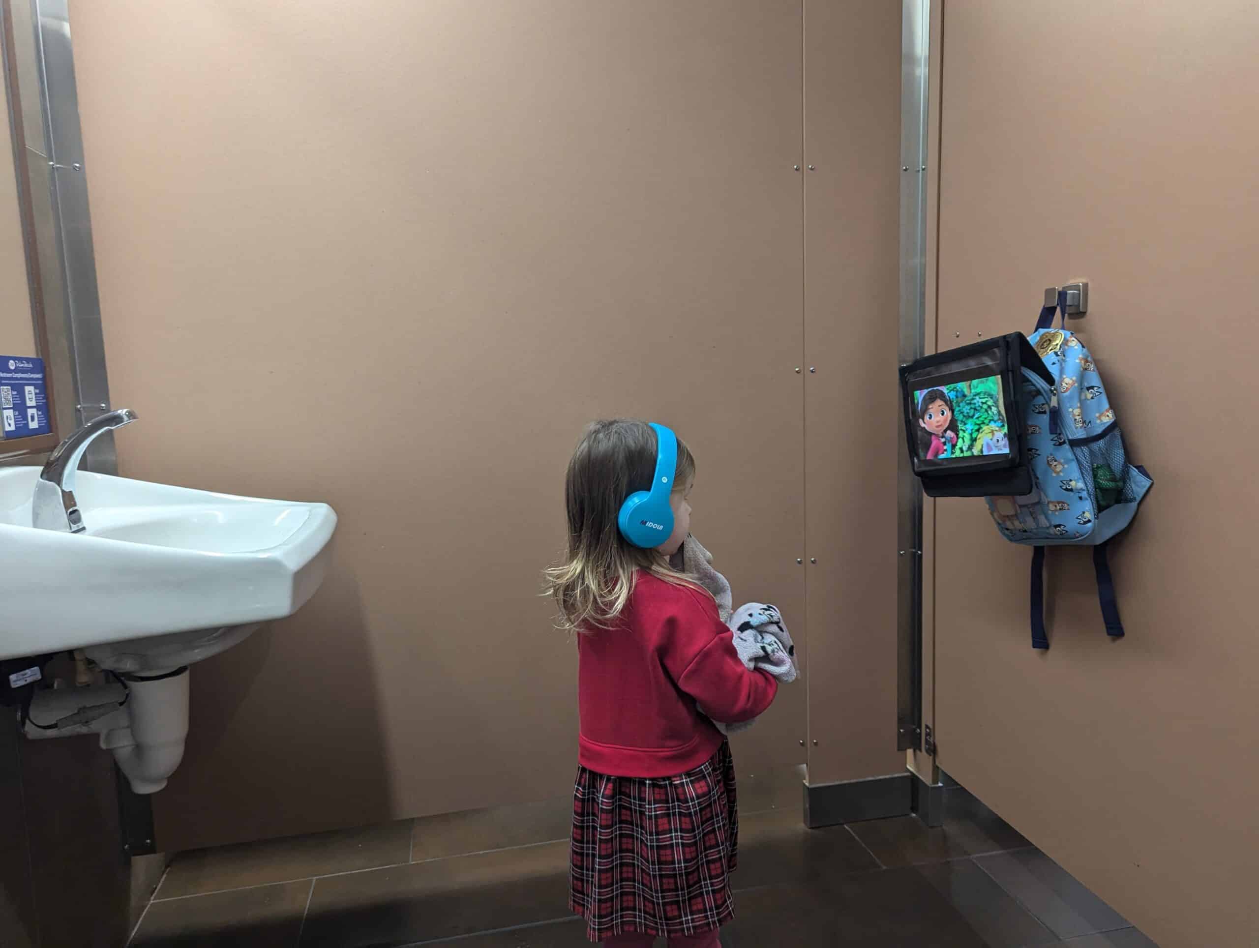 My toddler watching a show on her tablet while in the bathroom at the airport.