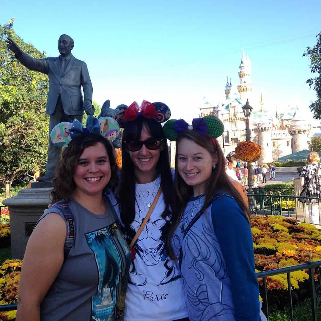 Me and two friends in front of the Walt and Mickey statue in Disneyland CA